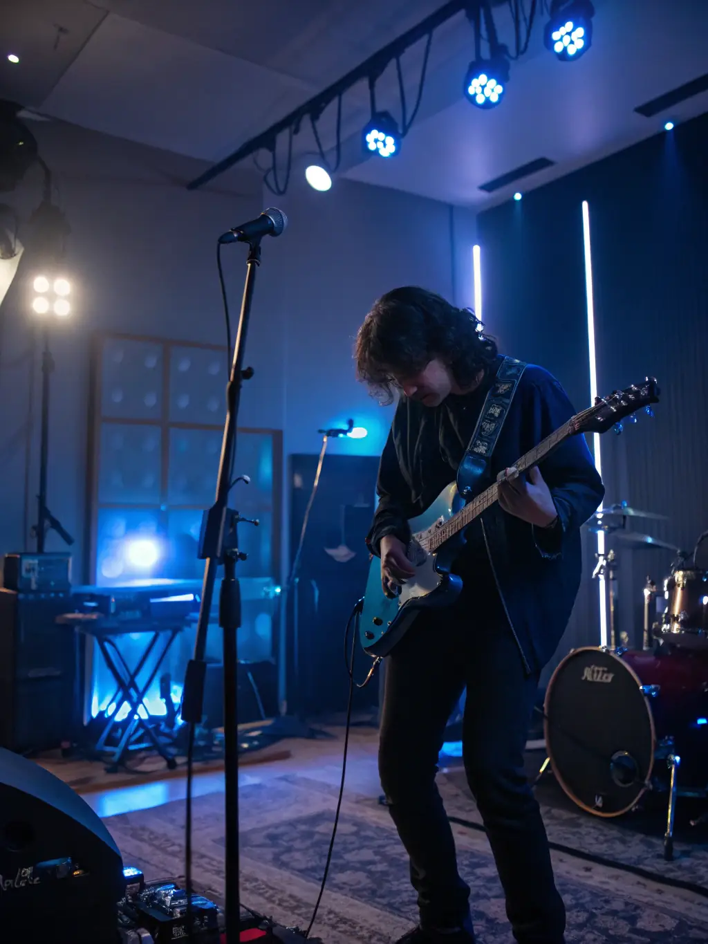 A musician playing a guitar in a recording studio, capturing the raw energy and emotion of the performance at ItzDee Productions.